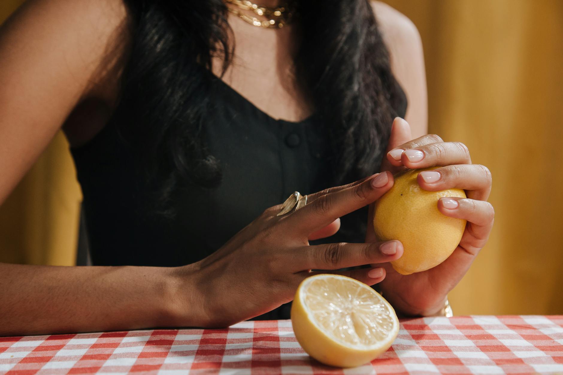 Woman holding fresh lemon, representing natural restoration of desire and wellness