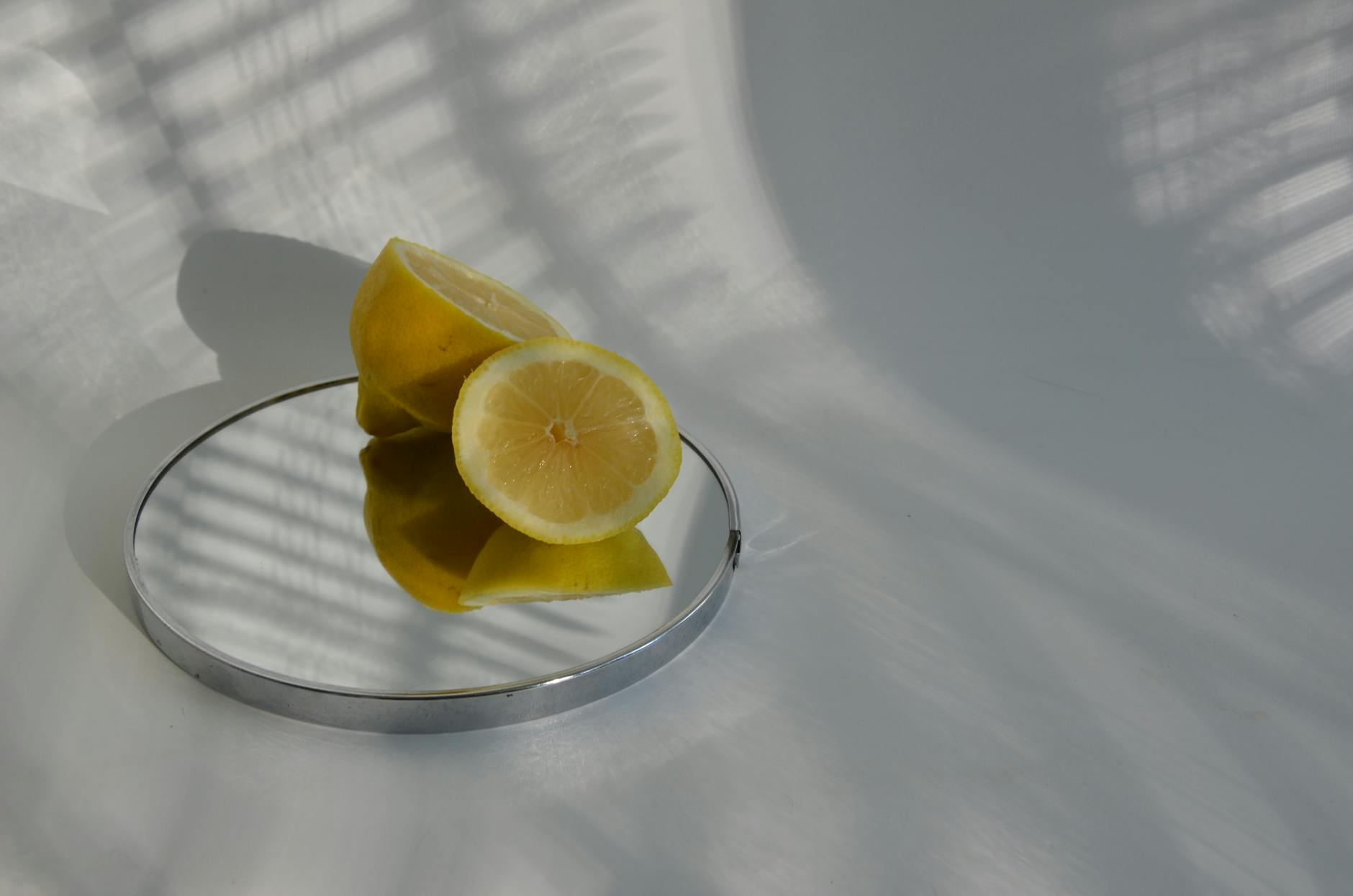 Woman holding lemon clitoral vibrators with thoughtful expression, exploring sensation and pleasure