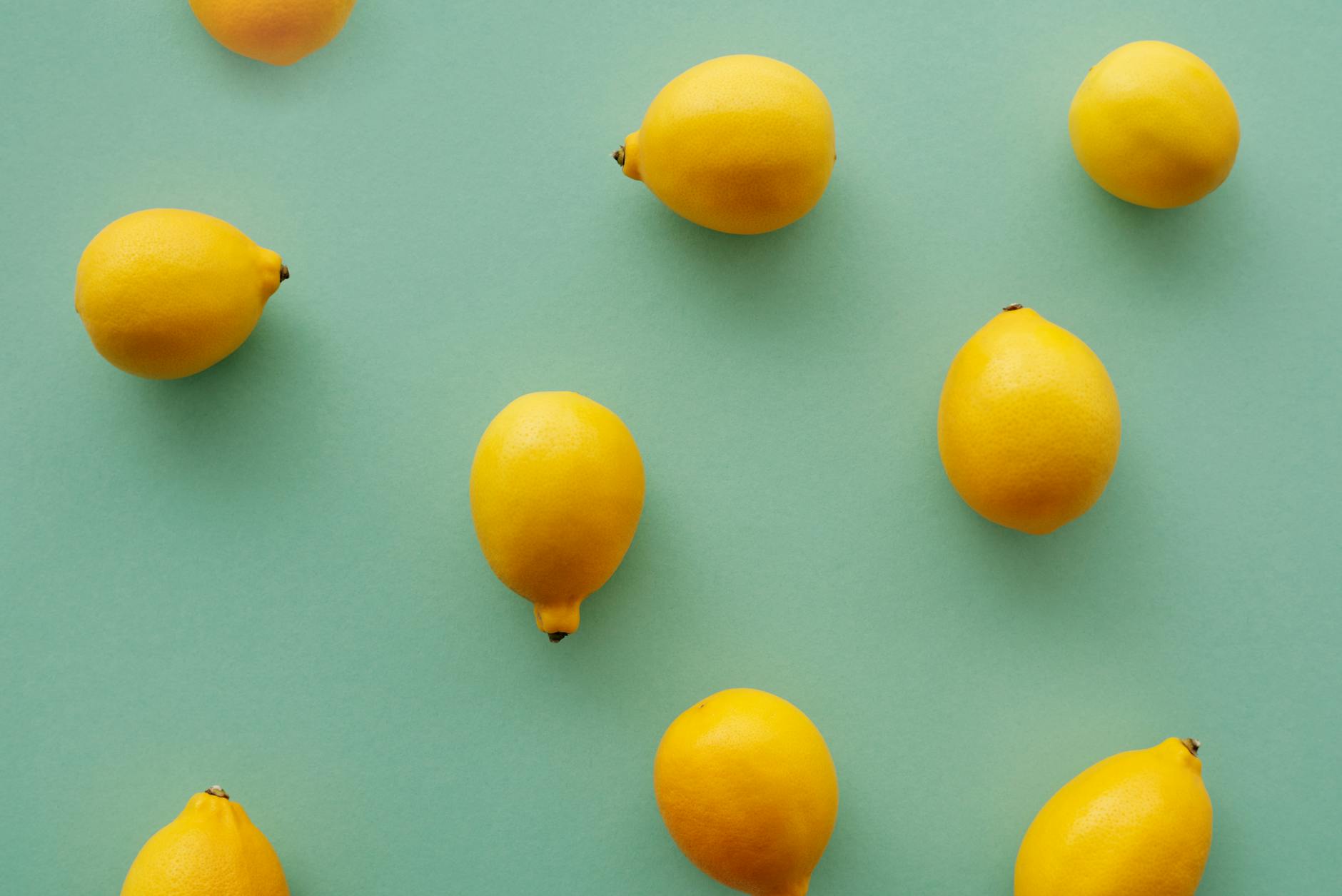 Colorful clitoral vibrators arranged on bright yellow background, showcasing lemon sexual toys and adult toys for solo exploration